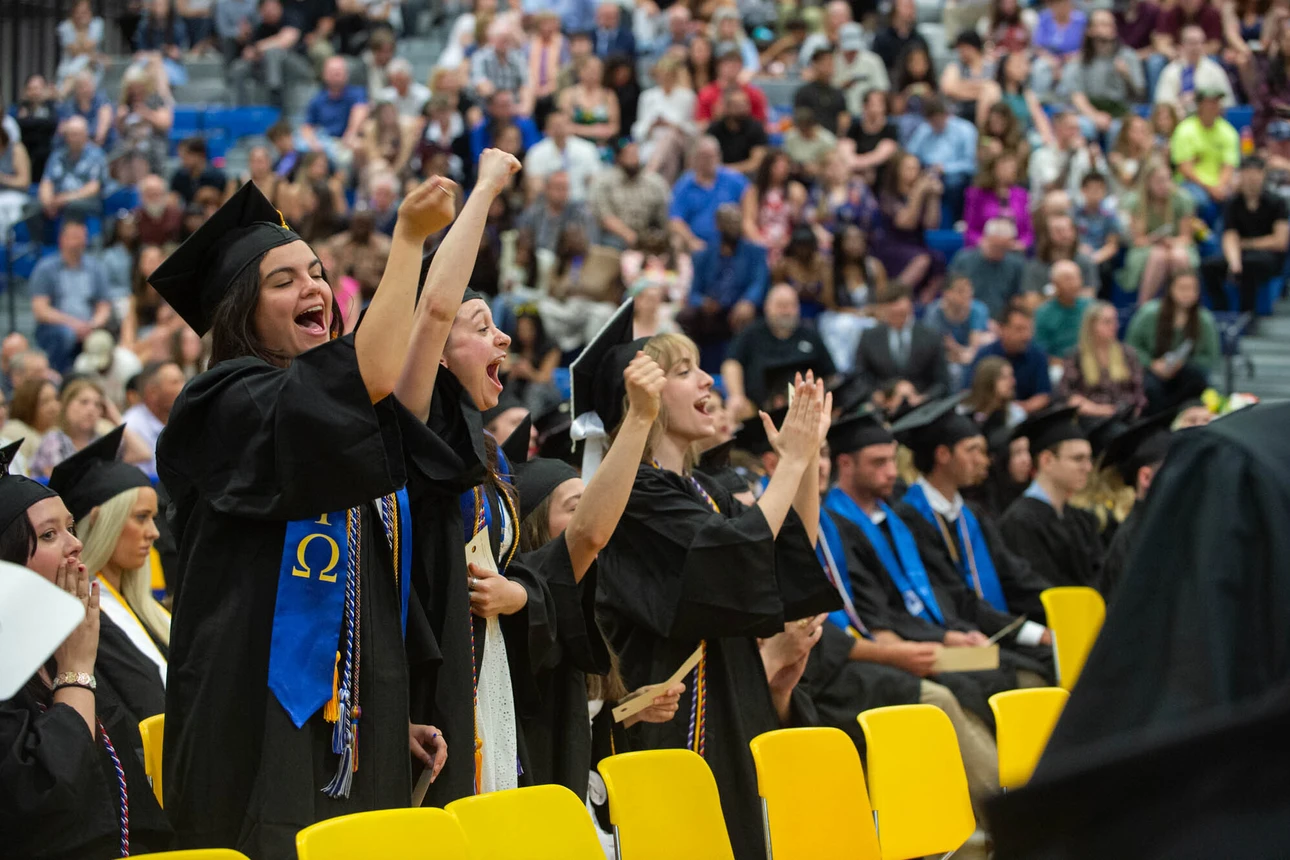 Graduates cheering for their fellow students