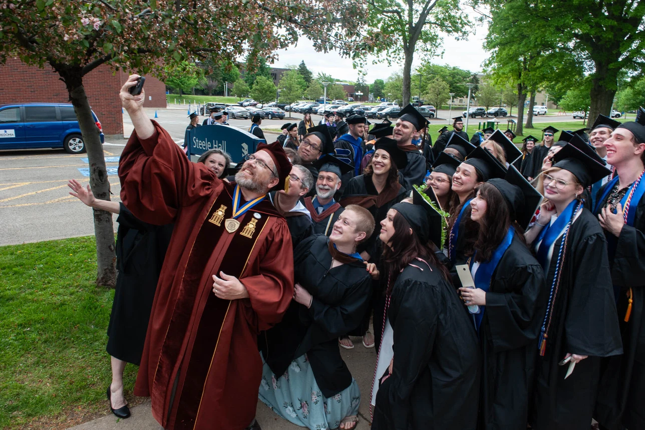Fredonia students pose with a favorite professor and mentor 