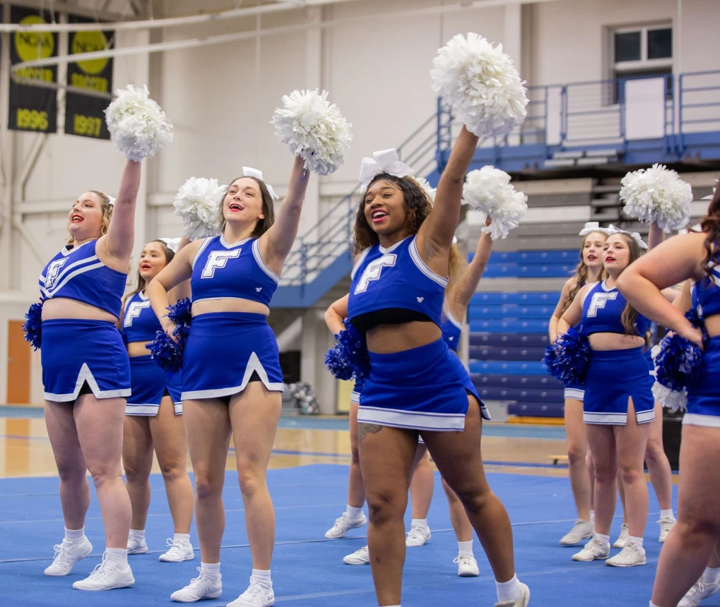Cheerleaders with hands raised