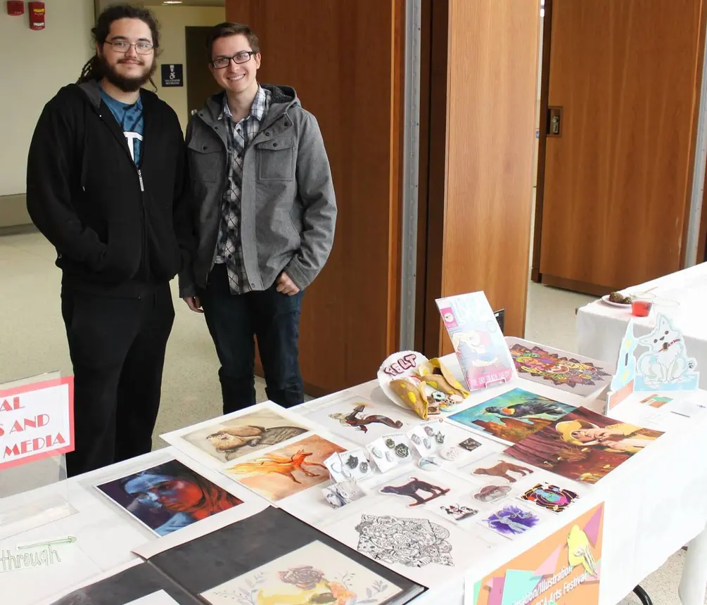 Students with visual art display at past Expo.