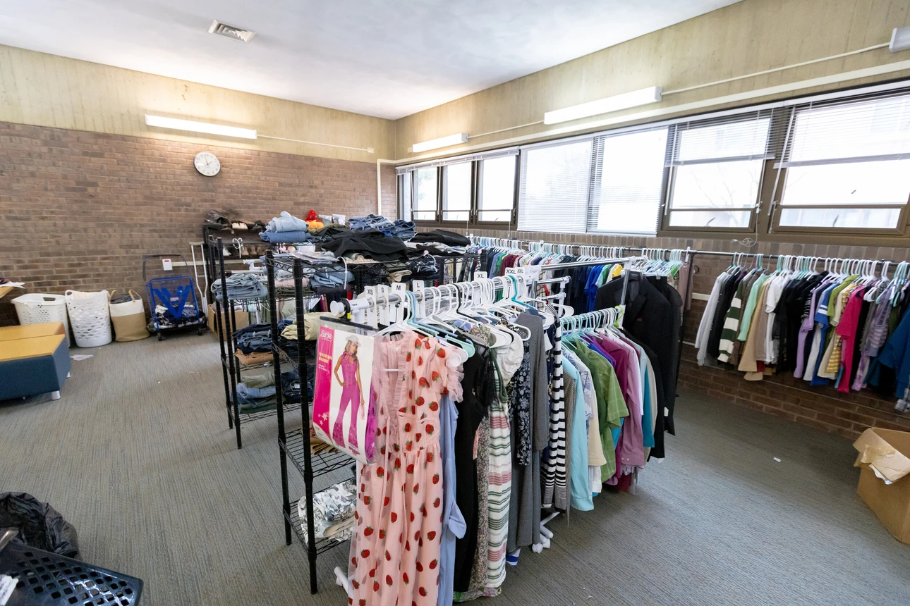 Racks of clothing in the middle of a room