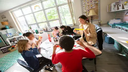 A first-year student works with elementary students at a local school.