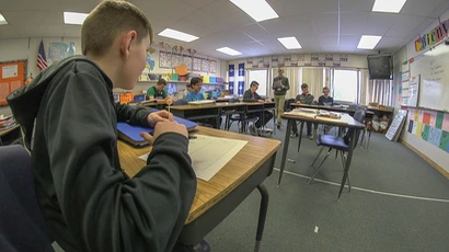 a fredonia student teaches children in a local classroom
