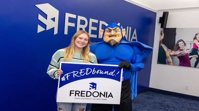 Student with the Blue Devil mascot. 