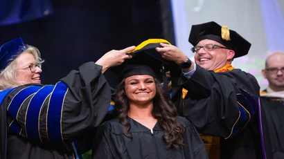 A graduate student accepts a degree