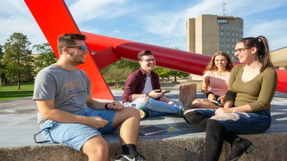 students relaxing on the steps near Reed Library