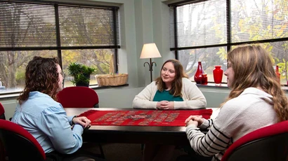students in a counseling session at a table