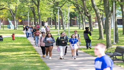 Students crossing campus between classes. free application week, free suny app