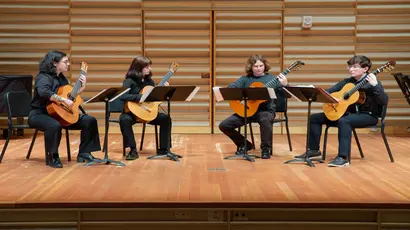 Fredonia music students performing with guitars on stage