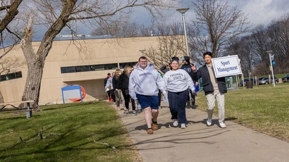 students lead a trou group across campus