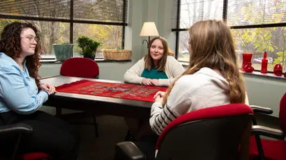 students sitting at table; masters degree clinical mental health counseling 