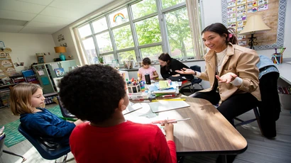 Fredonia student teacher working with students in a classroom
