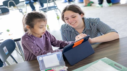 Student teacher working with a student representing TESOL instruction