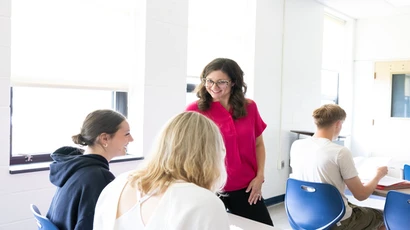 Educational leader working with students in a classroom
