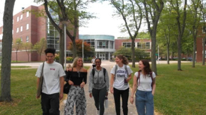 Fredonia student walking across campus on a typical spring day, low tuition, affordable, best SUNY schools
