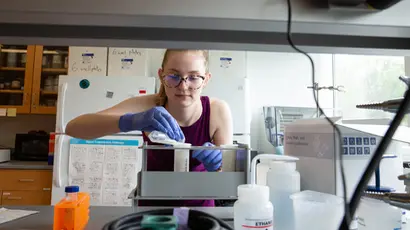 STEM student working with chemicals in the molecular genetics lab