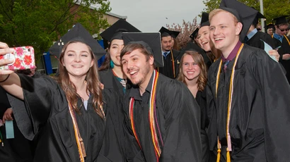 graduates pose for photo