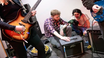 Students setting up amp for a live performance