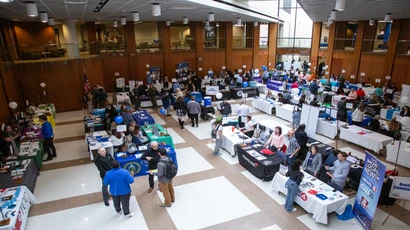 Students networking with employers at job fair event