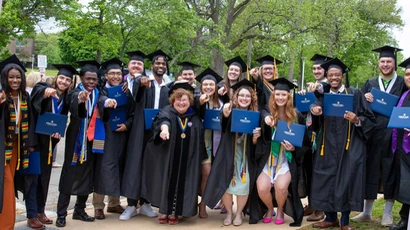 Graduates celebrate outside after their commencement ceremony.