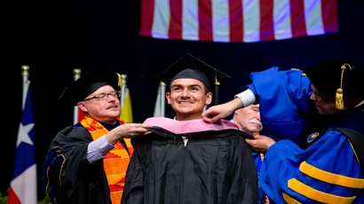 Fredonia students in a typical classroom smiling. Students can pursue a variety of graduate degrees at Fredonia, one of the least expensive and most affordable schools in the nation. 