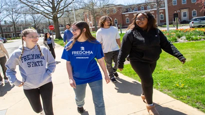 Fredonia students walking across campus on a typical spring afternoon