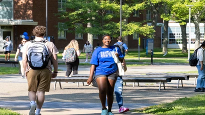student crossing campus. At Fredonia, students enjoy lower tuition, excellent research facilities, and a welcoming environment like no other. 