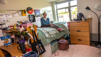 Student in dorm room within Honors House
