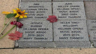flowers resting on engraved bricks