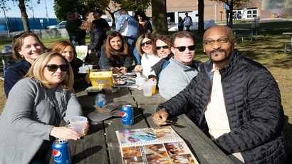 alumni gather for a photo at a reunion event