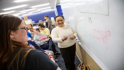 Professor and student at a whiteboard