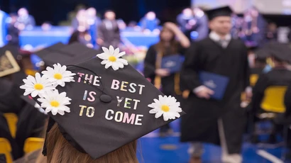 a hat at commencement that reads "the best is yet to come"