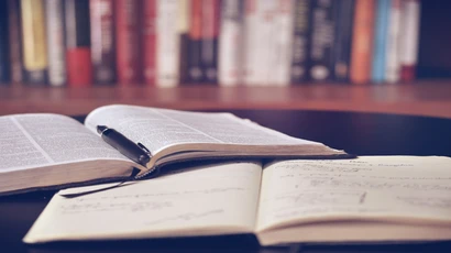 open book on a desk in a library