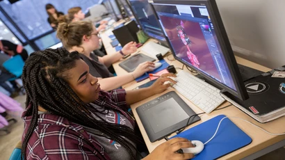 An animation student works on a computer during class, working towards bachelors degree in animation and illustration.