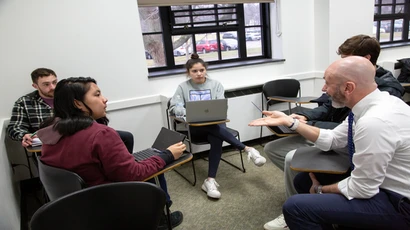 Fredonia students engaging with a professor in an accounting class, working in the accounting program, accounting degree as an accounting major toward a degree in accounting