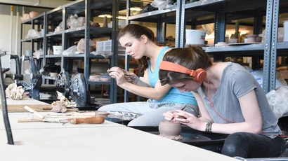 Students working with clay in the studio toward their ceramics degree, or degree in ceramics 