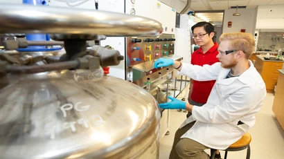 Dr. Allan Cardenas assists Alex Green in a Science Center lab. Biochemistry major, major in biochemistry, biochemistry degree.