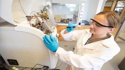 Cooperative engineering major program student makes an adjustment on equipment in the Science Center. Engineering major program colleges in New York.