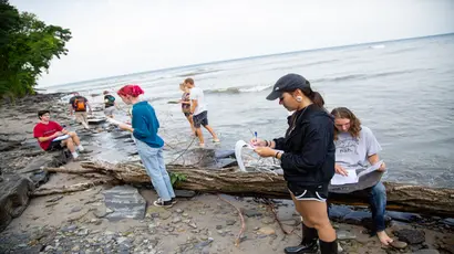 a geology class examines rock specimens. Geology degree, geologist degree, degree in geology, major in geology