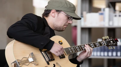 School of Music guitarist John Tocco performs during an informal noontime gathering in Reed Library.