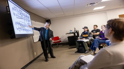 Music professor teaching a classroom of students