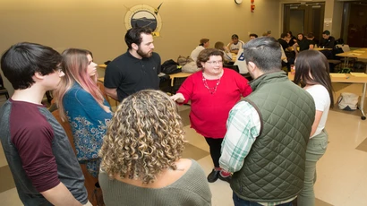 Fredonia business students at an event with a professor, students at Fredonia earn Degrees in Business Management, Degree of Business Management, Accounting degrees, and Finance degrees, MBA degrees, Degree in Business Management, Degree of Business Management