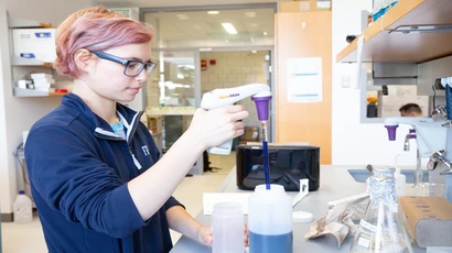 Student working in Science Center lab. Graduate biology program, graduate biology degree, graduate biology major, degree in graduate biology, biology major. 