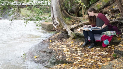 a student paints along the edge of local creek; drawing and painting degree; degree in drawing and painting; ba in drawing and painting, drawing and painting degree; degree in drawing and painting; ba in drawing and painting, drawing painting.
