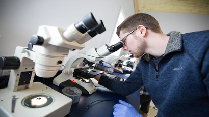 Students Jennifer Able and Jeremy Smith run tests and record data during their spring internships at TimberFish.  master biology.