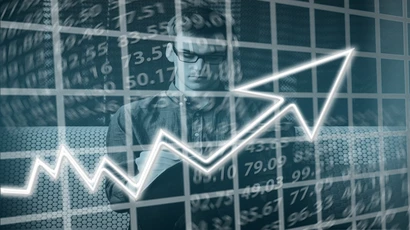 a graphic design image showing an economic chart and a student writing on a tablet.; economics major, econ major, What is economics