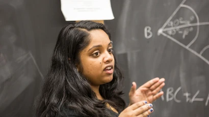 a student explains a math problem to other students. major in mathematics, mathematics major, mathematics degree, degree in mathematics, math degrees.