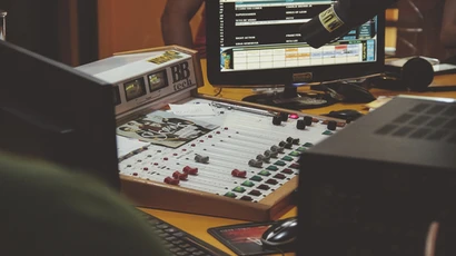 generic photo of a soundboard and computer screen