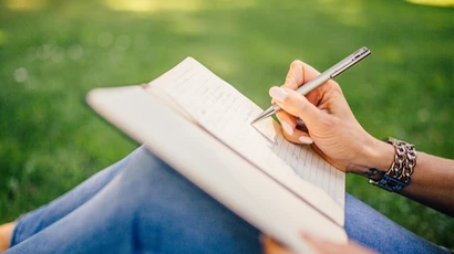 person writing in notebook, writing program, writing bachelors degree