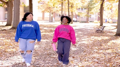 students walking across Fredonia campus
